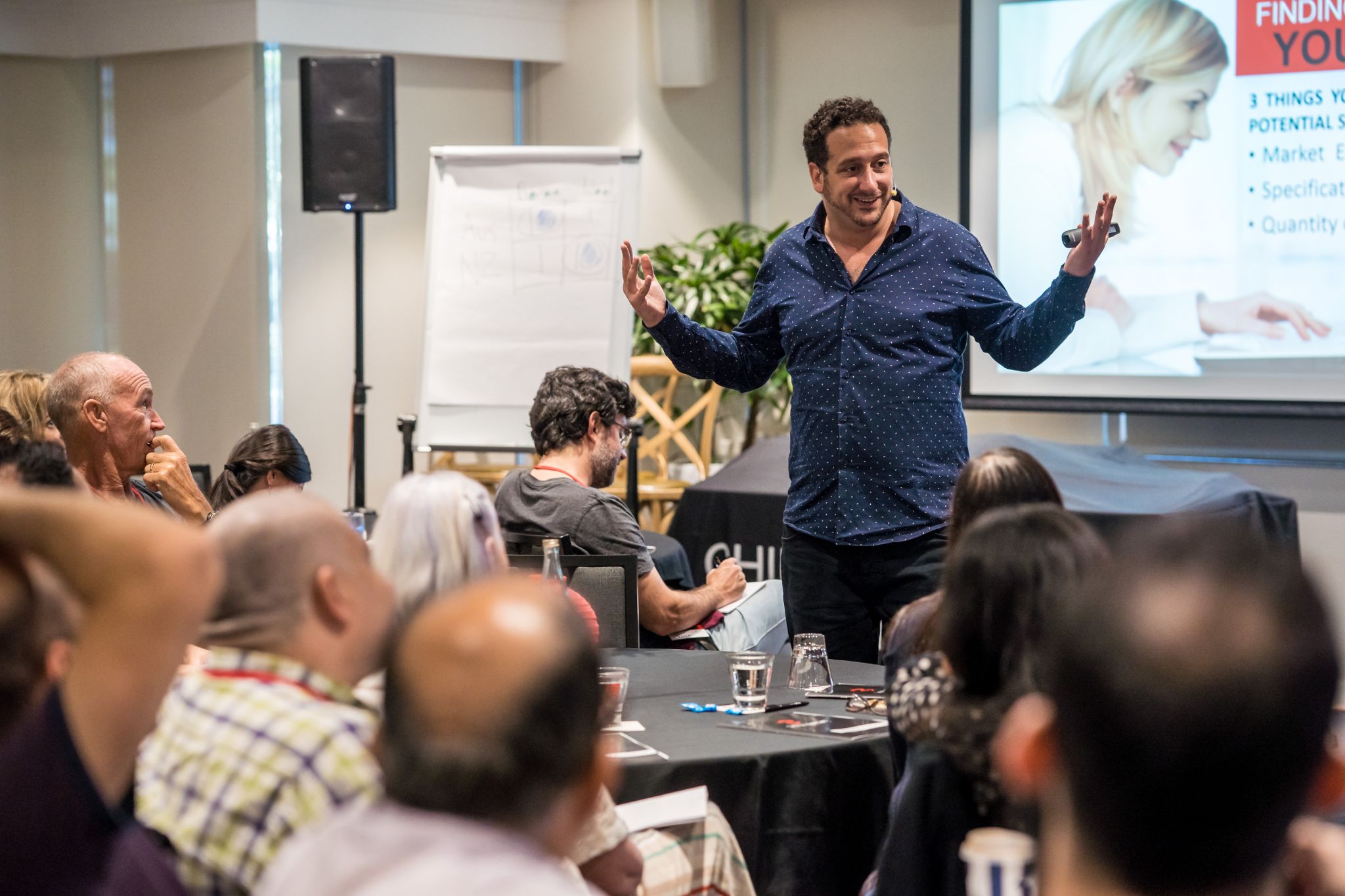 Brendan presenting to engaged audience at live event